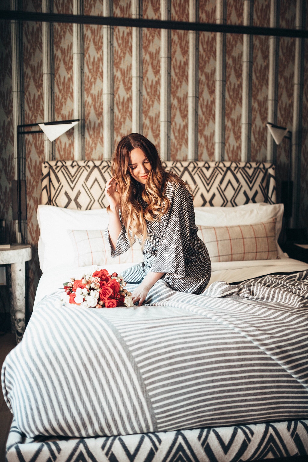 How To Have a Stress-Free Valentine’s Day featured by top US life and style blog, Just Add Glam: image of a woman on her bed with a romantic bouquet in her hands