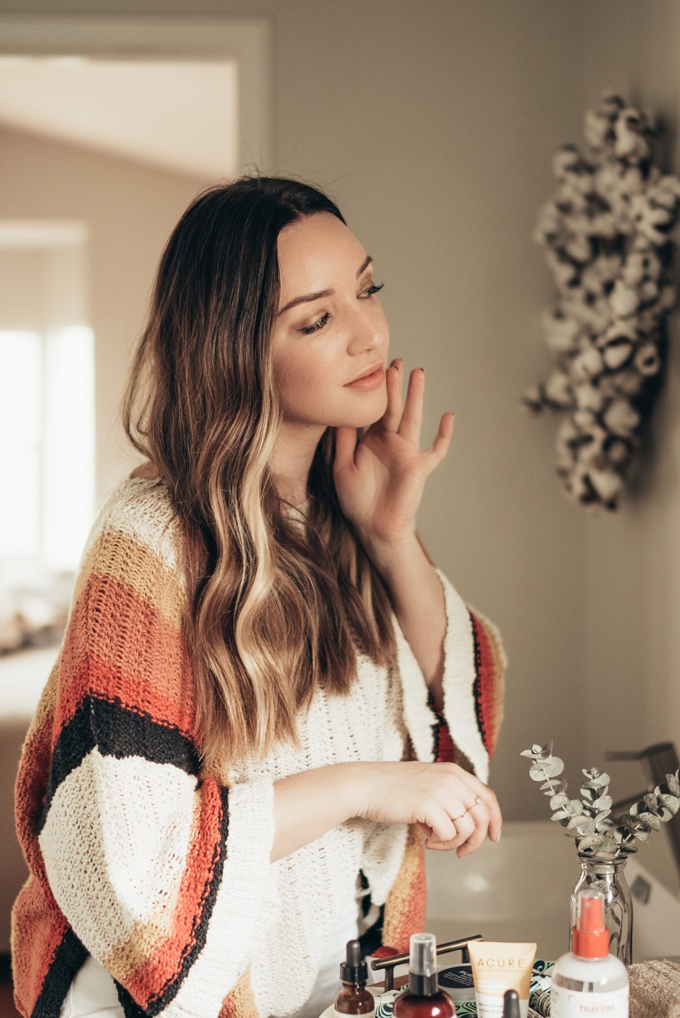 Best Natural Beauty Products featured by top US beauty blog Just Add Glam; Image of a woman wearing a striped cardigan.
