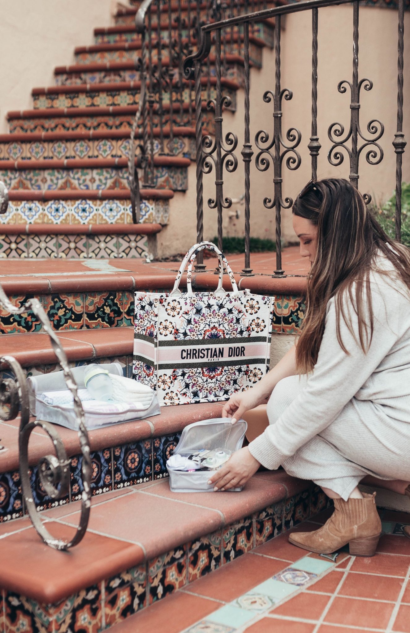 Top Deals On Must-Have Baby Essentials From Walmart by popular San Francisco life and style blog, Just Add Glam: image of a woman going through a bag with Walmart baby essentials in it.