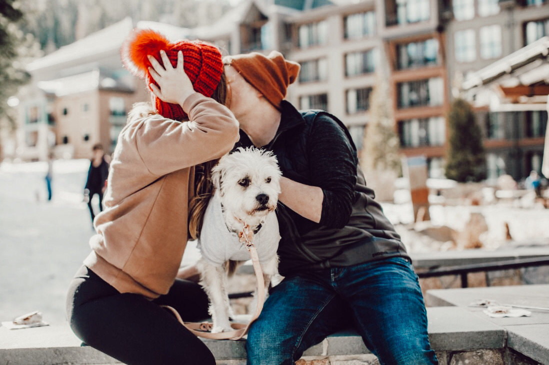 How to Set Expectations by popular San Francisco life and style blog, Just Add Glam: image of a man and woman sitting outside with their dog and kissing. 