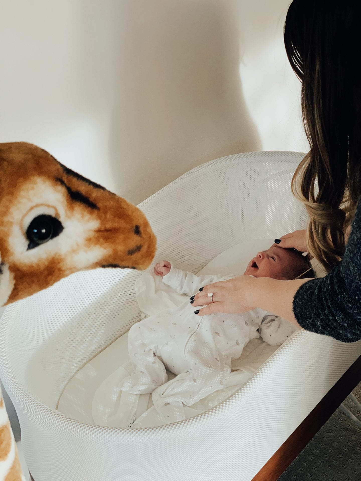 Baby Snoo Bassinet Review by popular San Francisco life and style blog, Just Add Glam: image of a mom looking at her baby in a Snoo Bassinet. 