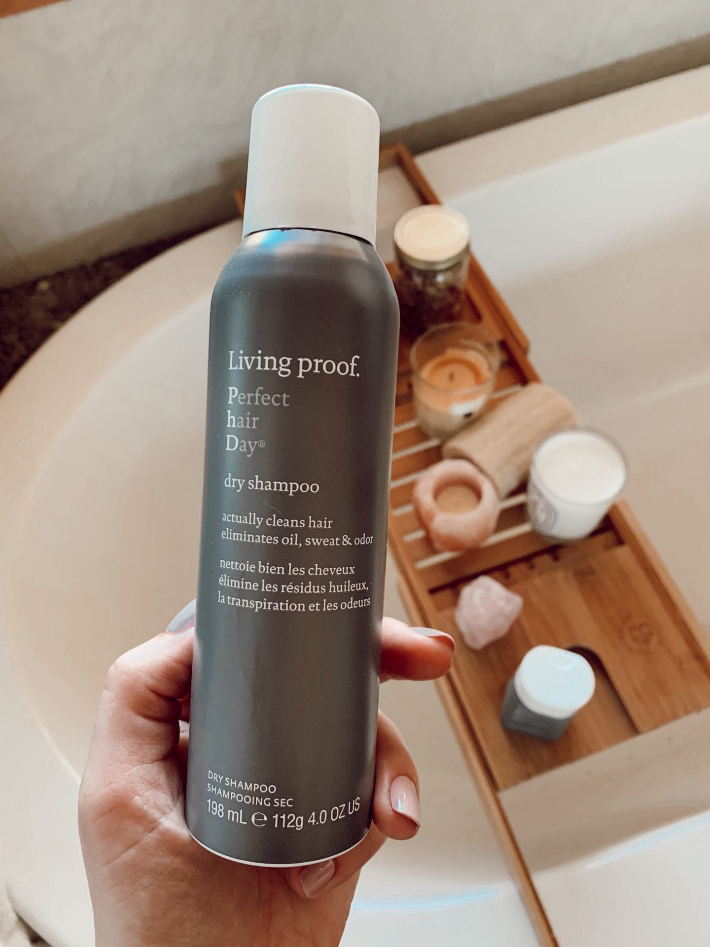 living proof hair | Living Proof Hair Products by popular San Francisco lifestyle blog, Just Add Glam: image of a woman holding a bottle of Living Proof dry shampoo. 