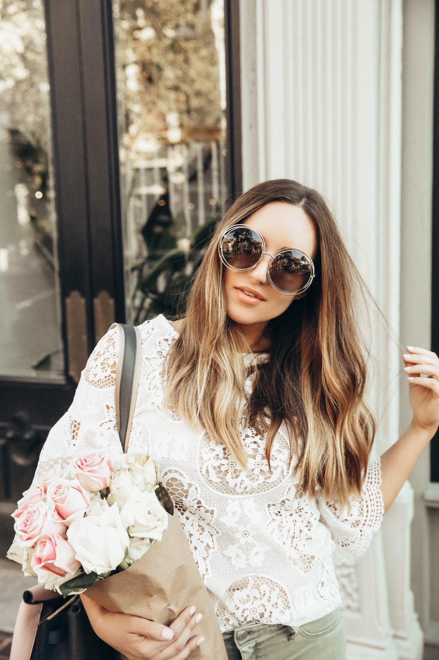 living proof hair | Living Proof Hair Products by popular San Francisco lifestyle blog, Just Add Glam: image of a woman standing outside, holding a bouquet of white and pink roses and running her fingers through her hair. 