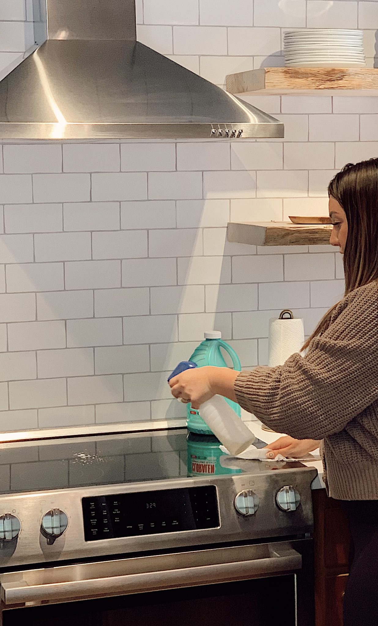 Cleaning with CLORALEN |Spring Cleaning Tips by popular San Francisco lifestyle blog, Just Add Glam: image of a woman holding a spray bottle and spraying a cleaning solution on to her stop top. 