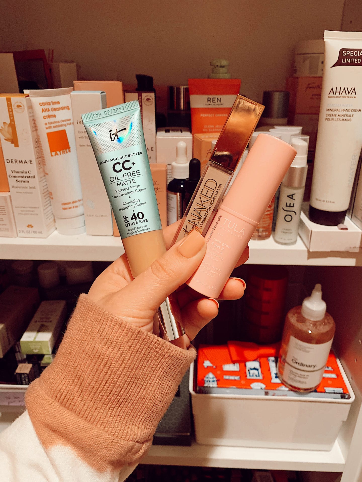 Ulta 21 Days of Beauty Sale | Ulta 21 Days of Beauty Sale by popular San Francisco beauty blog, Just Add Glam: image of a woman holding it CC cream, it Naked concealer, and Tula rose glow. 