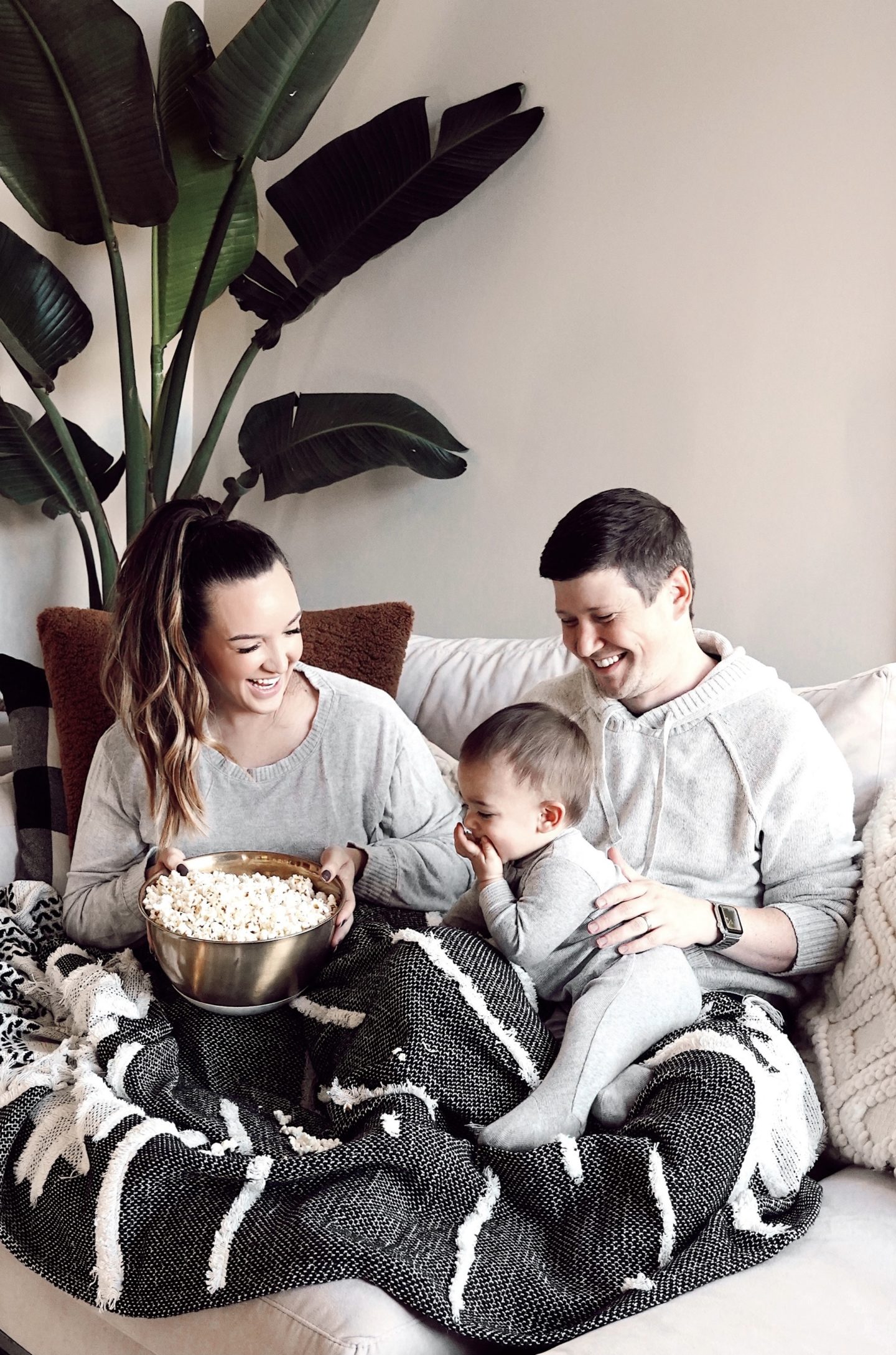 minted holiday cards 2020 |Minted Christmas Cards by popular San Francisco lifestyle blog, Just Add Glam: image of a mom and dad sitting on a couch with their young son while eating a bowl of popcorn. 