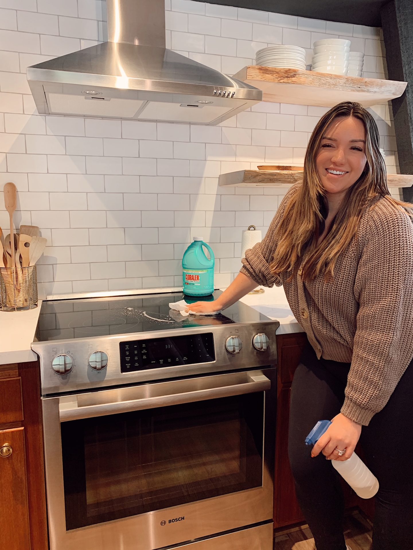 Cleaning with CLORALEN |Spring Cleaning Tips by popular San Francisco lifestyle blog, Just Add Glam: image of a woman holding a plastic spray bottle and wiping down her stove top. 